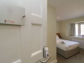 A bedroom with a bed and window at The Treetop Nook in Chudleigh