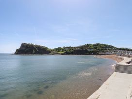 A beach with water and hills at Harcombe House Rooms - First Floor Double in Chudleigh