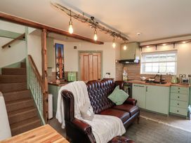 A living room with kitchen elements at Driftwood in Flamborough