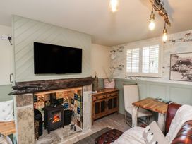 A snug with a fireplace and television at Driftwood in Flamborough
