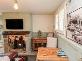 A living room with a television and fireplace at Driftwood in Flamborough