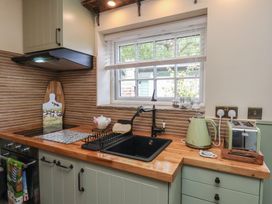 A kitchen with a sink and appliances at Driftwood in Flamborough