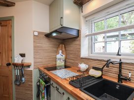 A kitchen with a sink, stove, and cooking utensils at Driftwood in Flamborough