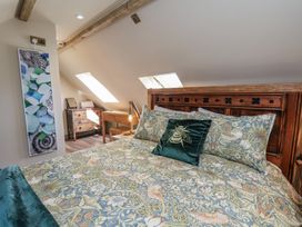 A bedroom with a bed and desk at Driftwood in Flamborough