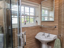 A bathroom with a shower and sink at Driftwood in Flamborough
