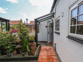An outdoor area with a pathway and flowers at Driftwood in Flamborough