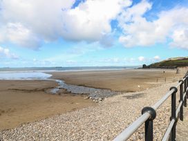 A beach view with water and clouds at Puffin Nook in Broad Haven
