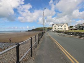 A beachside road with a building at Puffin Nook in Broad Haven