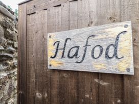 A wooden sign with the name Hafod on a fence at Hafod in Llangollen