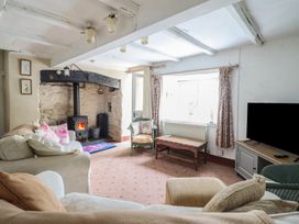 A living room with a fireplace and a television at Hafod in Llangollen