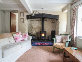 A living room with a fireplace and sofa at Hafod in Llangollen