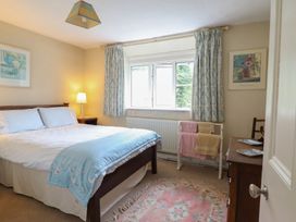 A bedroom with a bed and window at Hafod in Llangollen