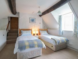 A bedroom with twin beds and a staircase at Hafod in Llangollen