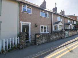 A house with a door and windows on Llanwast Road in Conwy