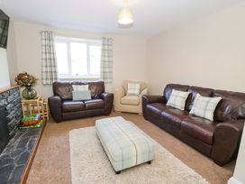 A living room with sofas and a coffee table at Bryn Hyfryd in Conwy