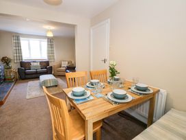 A dining area with a table set for meals at Bryn Hyfryd in Conwy