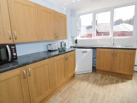 A kitchen with a microwave kettle and dishwasher at Bryn Hyfryd in Conwy