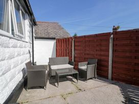 An outdoor seating area with table and chairs at Bryn Hyfryd in Conwy