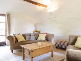 A living room with a sofa and coffee table at Cyffdy Cottage - Arenig in Bala
