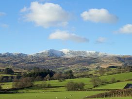 A landscape with mountains and fields at Cyffdy Cottage - Arenig, Bala