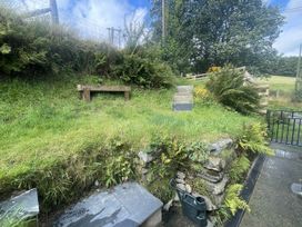 A garden with a wooden bench and stone steps at 1 Bryn Ysgol Ysbyty Ifan near Betws-Y-Coed