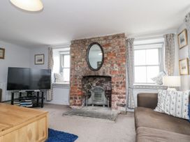 A living room with a fireplace and television at Shelstone in Whitby