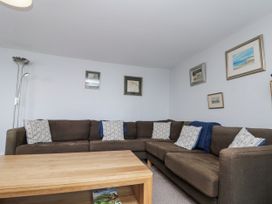 A living room with a sectional sofa and coffee table at Shelstone in Whitby