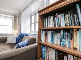 A living room with a sofa and bookshelf at Shelstone in Whitby