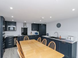 A kitchen with cabinets and dining table at Shelstone in Whitby