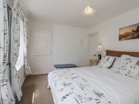 A bedroom with a bed and nightstand at Shelstone in Whitby