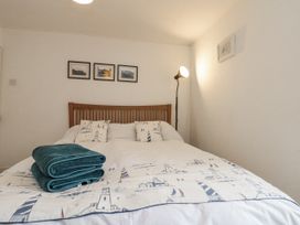 A bedroom with a bed and lamps at Shelstone in Whitby