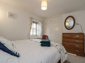 A bedroom with a bed and dresser at Shelstone in Whitby
