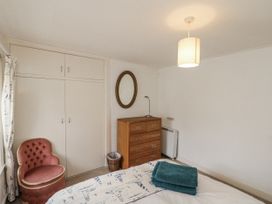 A bedroom featuring a bed with towels and a dresser at Shelstone in Whitby