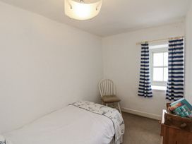 A bedroom with a bed and a chair at Shelstone in Whitby