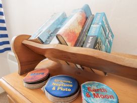 A bookstand with books and coasters at Shelstone in Whitby