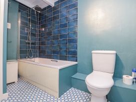 A bathroom with a bathtub and toilet at Shelstone in Whitby