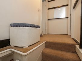 A staircase with a storage box in a hallway at Shelstone in Whitby