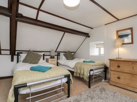 A bedroom with two single beds and a dresser at Shelstone in Whitby