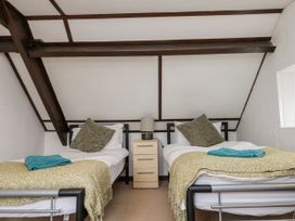 A bedroom with two beds and a nightstand at Shelstone in Whitby