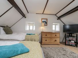 A bedroom with two beds and a television at Shelstone in Whitby