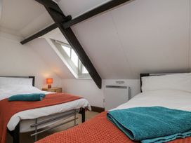 A bedroom with two beds and a window at Shelstone in Whitby