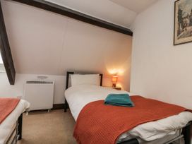 A bedroom with two beds and a lamp at Shelstone in Whitby