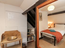 A bedroom with a bed and mirror at Shelstone in Whitby
