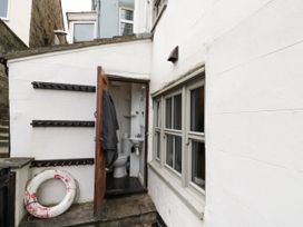 A bathroom with a toilet and sink at Shelstone in Whitby