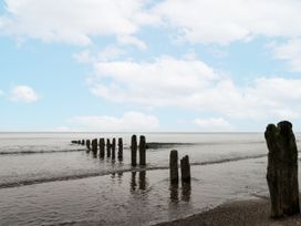 A view of wooden posts extending into the sea at Shelstone in Whitby