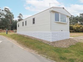 A white mobile home on a grassy plot near trees at 4 Foxburrow Hang in Fritton near Belton Norfolk