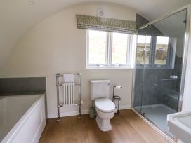 A bathroom with a bathtub toilet shower and heated towel rail at Insh Cullipool Isle Of Luing