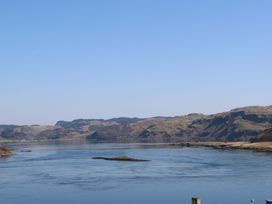 A body of water with hills in the background at Scarba in Cullipool Isle Of Luing