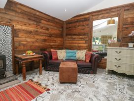 A living room with a sofa and coffee table at Lilac Cottage in Grange-Over-Sands