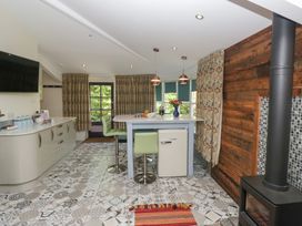 A kitchen with a countertop and refrigerator at Lilac Cottage in Grange-Over-Sands